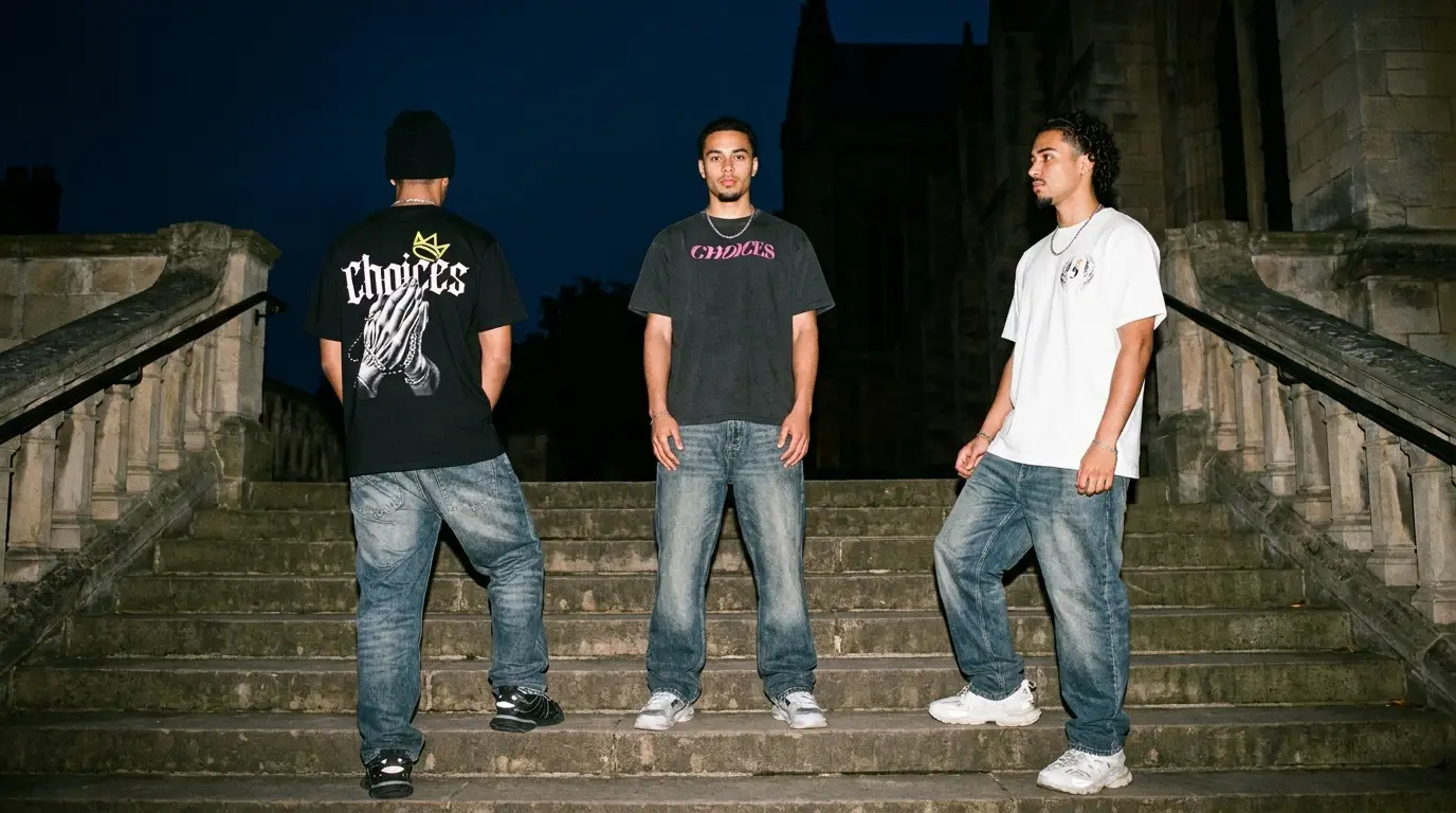 Drop 01 campaign: three models on stone cathedral steps at night wearing Drop 01 tees