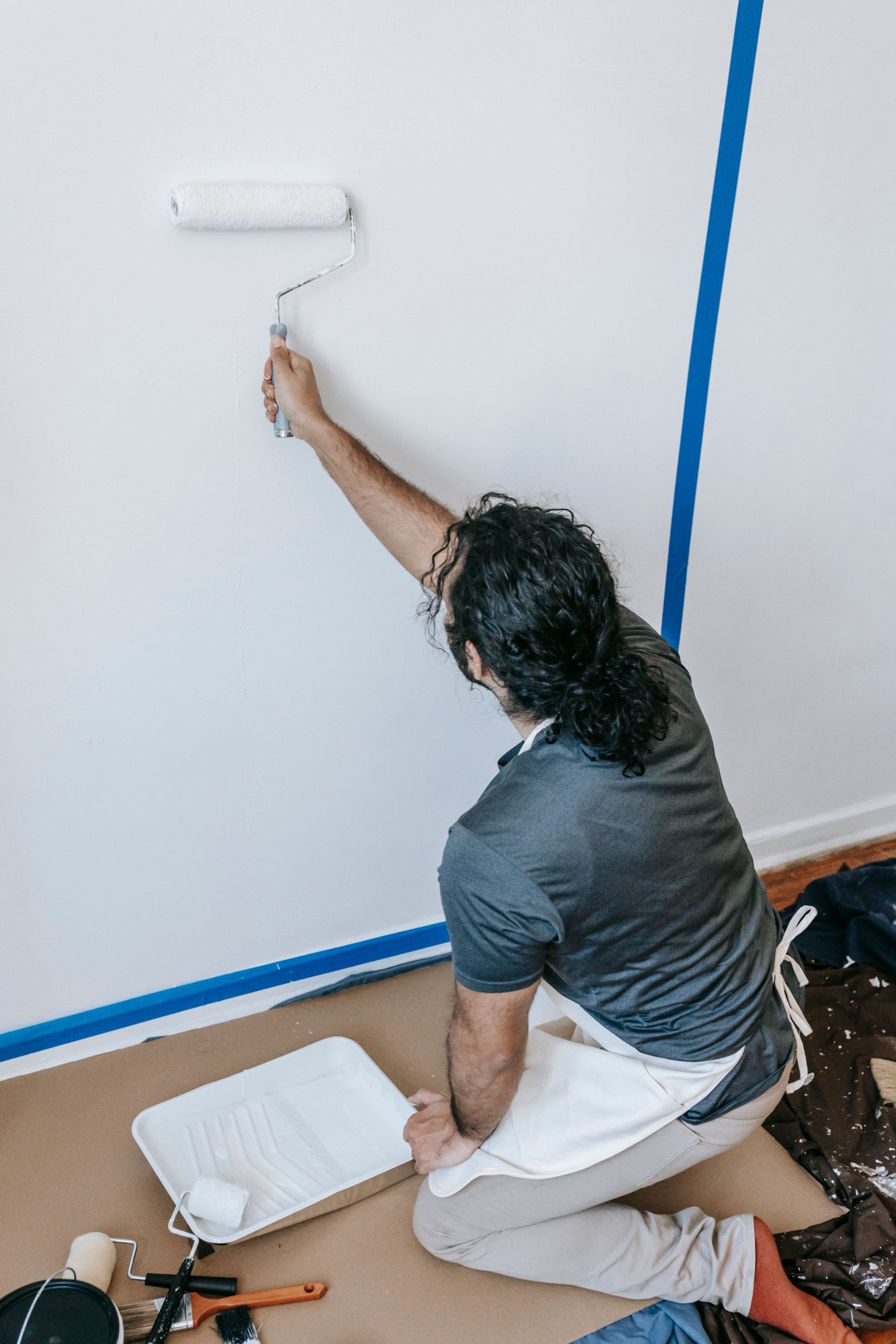 A decorator carefully painting a wall